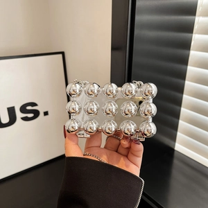 Mini mirror finish phone case with fifteen silver metal spheres and crossbody chain strap