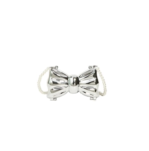 Detail view of silver bow-shaped metallic evening bag with white pearl chain strap