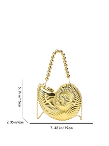 Detail of shell-shaped gold evening bag with vertical stripes and beaded handle
