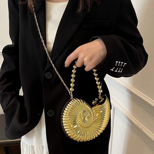 Chic golden conch-shaped acrylic evening bag with metallic chain and beaded handle