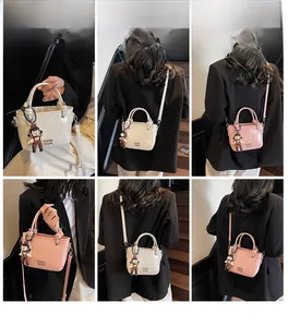 Model view of chic oily wax leather bucket bags in beige and pink colors with cute charms