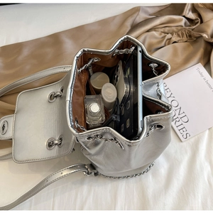 Interior detail of silver bucket bag showing large capacity for phone and cosmetics