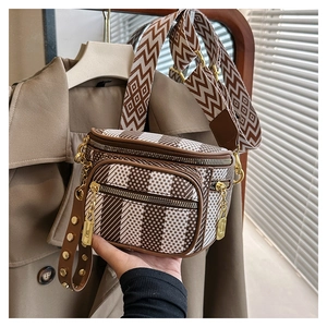 Detail of vintage saddle bag with geometric patterns and textured jacquard strap