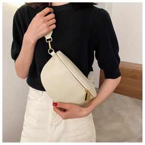 Detail view of cream lychee texture leather chest bag with premium golden hardware