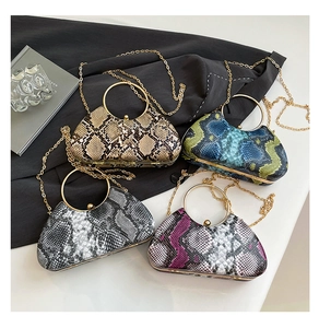 Close-up of snakeskin pattern evening bags in multiple colors with gold metal handles