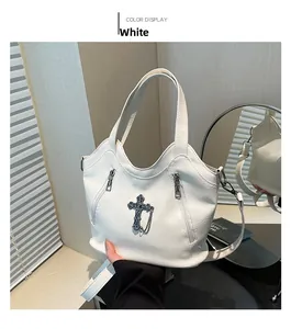 Close-up of white lychee grain PU leather bag with Gothic cross and chain details