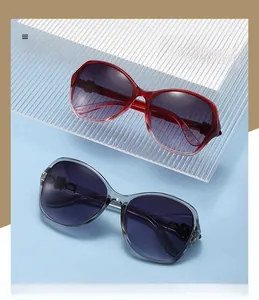 Detail of oversized sunglasses with floral metal accents and gradient purple lenses