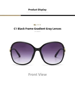 Front view of black oversized sunglasses with gradient lenses and gold metal accents