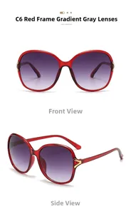 Detail of red oversized sunglasses with gradient grey lenses and golden V temple accent