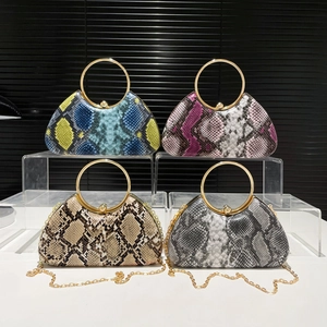 Elegant python pattern evening clutch bag with round metal handle and gold chain strap
