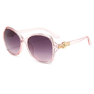 Pink oversized aviator sunglasses for women with gold metal temples on white background