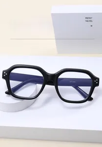 Detail view of black full-frame blue light blocking glasses with triple silver studs