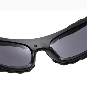 Macro detail of matte black sunglass frame with metallic screw nose bridge reinforcement