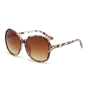 Oversized tortoise shell sunglasses with gradient brown lenses and gold V accent