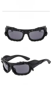 Detail view of matte black sunglasses with unique rope texture frame and grey lenses
