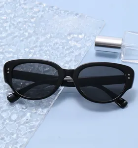 Detail of black oval sunglasses with silver studs and model BJ533 printed on temple