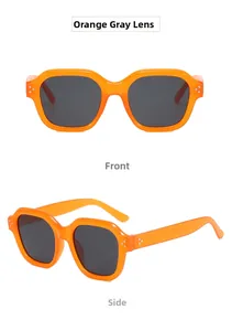 Detail view of jelly orange frames and dark gray lenses with classic metal rivets