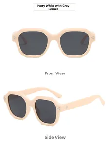 Close-up of ivory white hexagonal sunglasses with three-point metal rivets and grey lenses