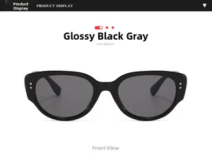 Close-up of retro black frame sunglasses with gray lenses and silver rivet details