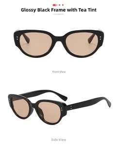 Detail of vintage cat-eye sunglasses in glossy black frame with brown tinted lenses