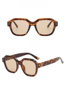 Front and side view of tortoiseshell oversized sunglasses with 3-dot rivets and brown lenses
