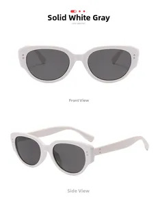 Detail of white vintage sunglasses with grey lenses and retro metal dot accents