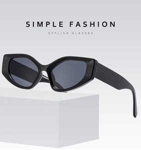 Detail of trendy black cat-eye sunglasses with thick geometric frames and dark lenses
