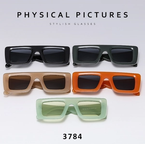 Flat lay of retro rectangle sunglasses in black, green, orange, and mint green colors