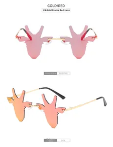 Vue détaillée des lunettes de soleil cerf dorées avec verres rouges et monture métal