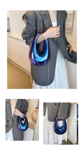 Detail of blue-purple gradient acrylic box bag with metallic finish and gold chain