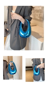 Detail of electric blue metallic acrylic box bag with unique U-shaped cutout and chain