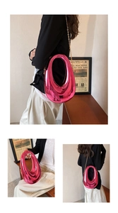 Detail of fuchsia acrylic box bag with streamlined teardrop cutout and gold chain strap