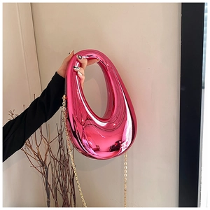 Close-up of fuchsia metallic acrylic box bag with sleek oval shape and gold chain strap