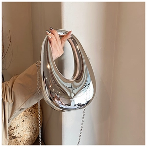 Close-up of a silver mirror pebble-shaped bag with unique hollow handle and chain