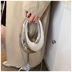 Close-up of a silver water-drop hollow clutch bag with a metallic chain strap