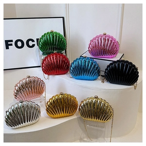 Close-up of shell-shaped evening bags in multiple metallic plated colors with chain straps