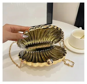 Close-up of golden shell evening clutch bag with metal chain and interior design details
