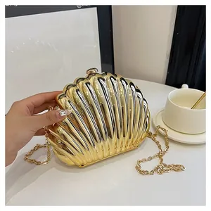 Detailed shot of a gold shell-shaped evening clutch with elegant radial ribbed texture