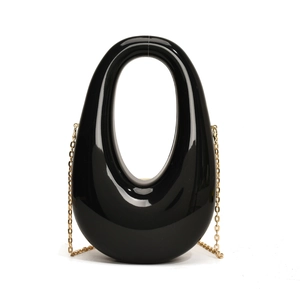 Glossy black acrylic egg-shaped evening bag with a metallic gold chain strap