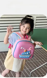 Close-up of pink hard-shell cartoon ship backpack for kids with blue zip details