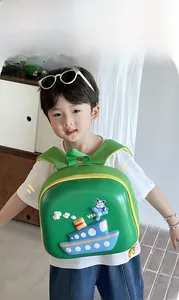Detail of child wearing a lightweight green 3D ship backpack with yellow zippers