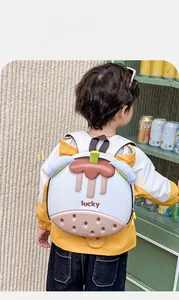 Kid back view showing cute cupcake-shaped EVA backpack with lucky print and wide straps