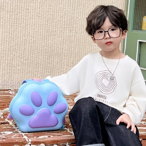 Blue and purple macaron-colored children's backpack with 3D cat paw design in outdoor setting