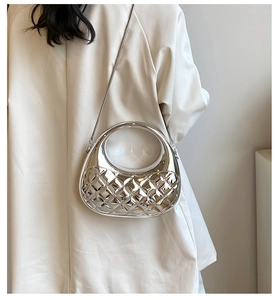 Detail of silver metallic quilted box bag with hollow ring handle and silver chain strap