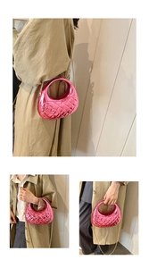 Detail of pink metallic quilted saddle bag showing texture and golden chain strap