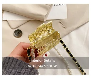Detail view of mini gold mesh bag featuring quilted interior and pearl chain strap