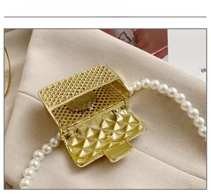 Mini gold lattice bag charm with pearl chain and coin for size reference comparison