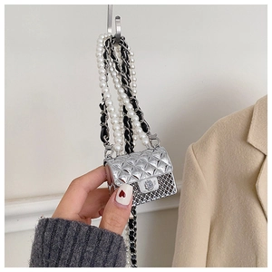 Detail of mini silver quilted handbag with pearl strap and crystal-encrusted closure