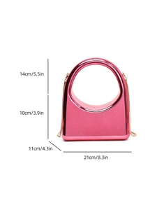Detail view of pink metallic evening bag with round handle and gold chain strap