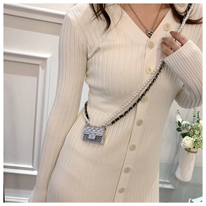 Micro mini silver quilted bag featuring pearl and metal chain straps on model
